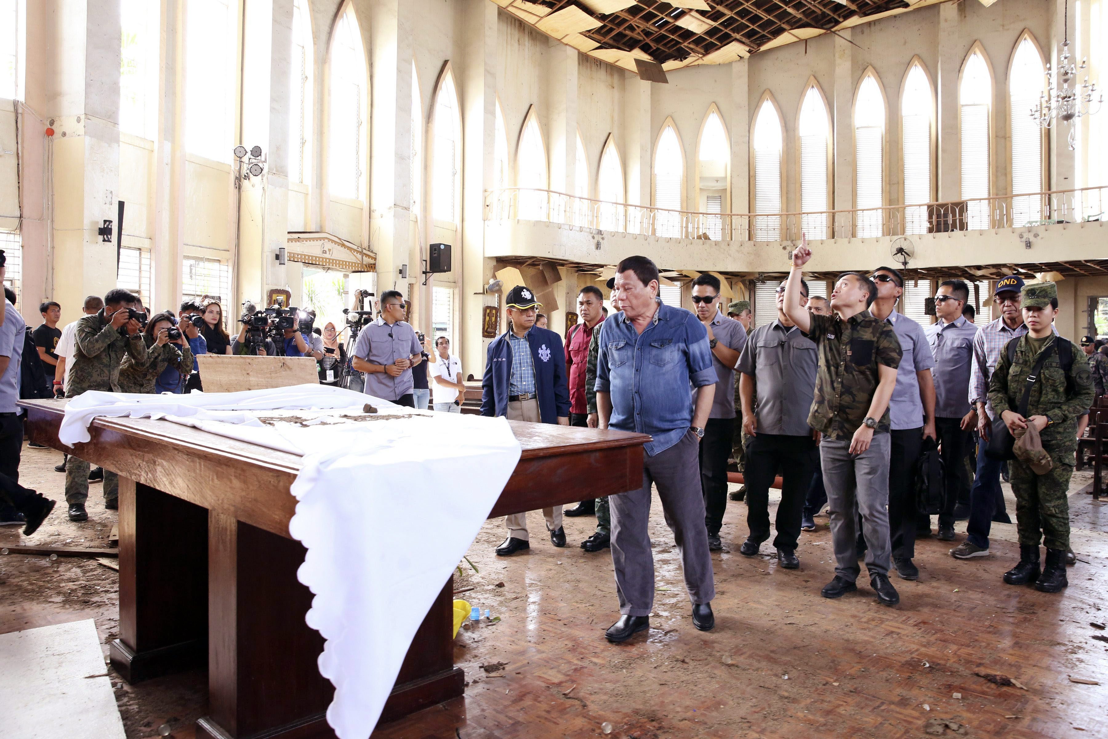 A handout photo made available by the Presidential Photographers Division shows President Duterte on Jan. 28, 2019 inspecting a Catholic church damaged by an explosion in Jolo, Sulu.